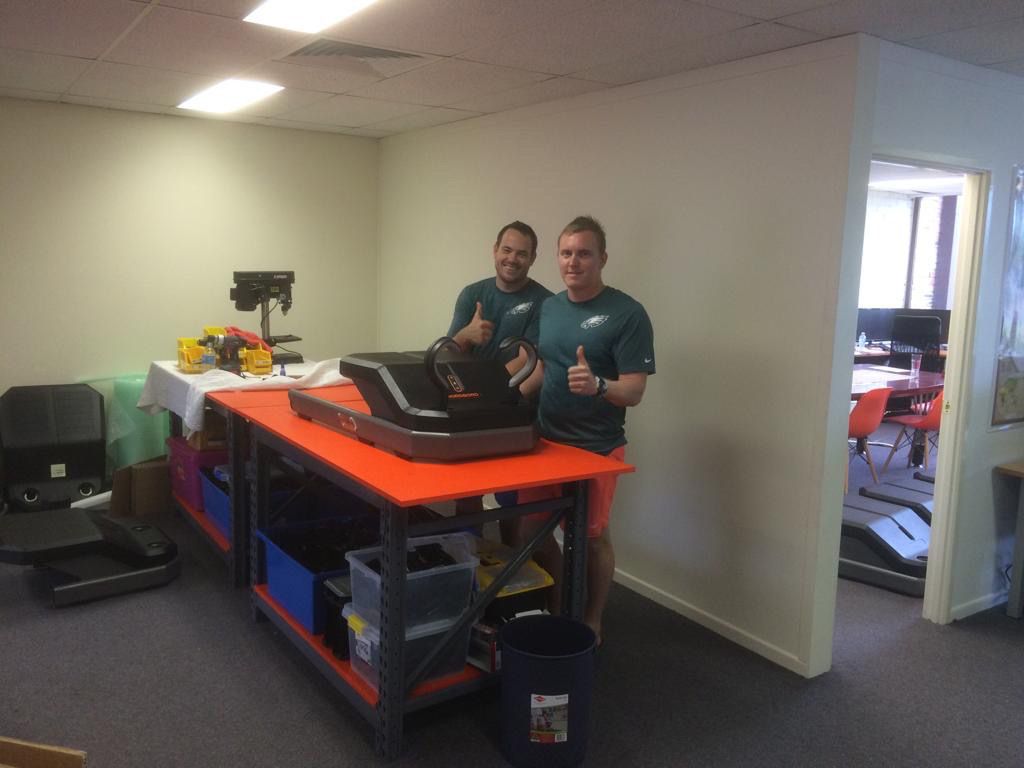 VALD co-founders Sam James and Laurie Malone in their first Brisbane office with an early NordBord prototype